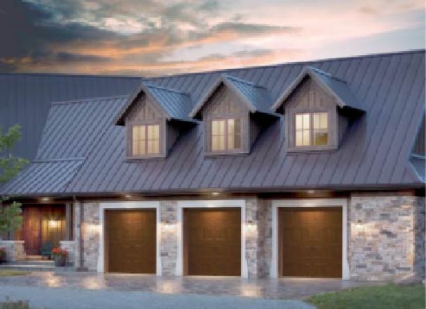 Modern contemporary house style with brown wood garage doors and grey roof.