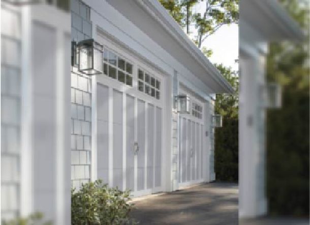 White modern contemporary house with white garage doors.