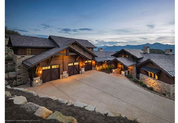 ide view of a modern contemporary house with brown wood garage doors.